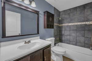 Full bath with  shower combination, vanity, and light tile patterned floors