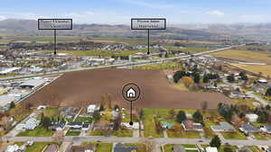 Aerial view of property's location featuring mountains and nearby suburban area