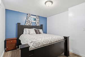 Bedroom featuring a textured ceiling and carpet