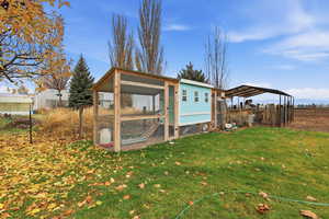 View of poultry coop featuring a detached carport