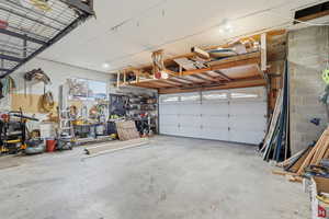 Garage featuring a workshop area and a garage door opener