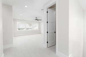 Empty room featuring light colored carpet, recessed lighting, and ceiling fan
