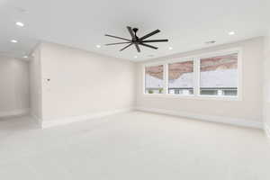 Spare room featuring recessed lighting, light colored carpet, and a ceiling fan