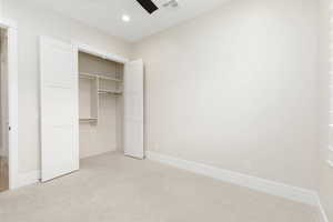 Unfurnished bedroom featuring carpet floors, a closet, recessed lighting, and ceiling fan