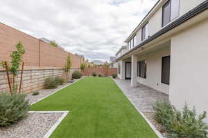 Fenced backyard with a patio