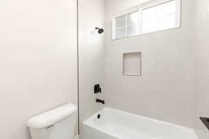 Full bathroom featuring bathing tub / shower combination and toilet