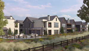 Back of property with stone siding, a residential view, a patio area, and outdoor lounge area