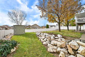 Fenced backyard with a storage unit