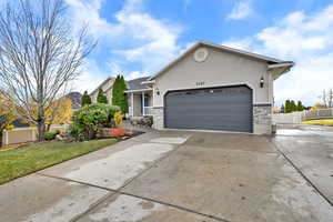 Ranch-style house with concrete driveway, a garage, stucco siding, and a porch