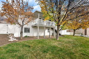 Back of house with a patio area, a wooden deck, a fenced backyard, and stairway