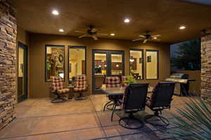 View of patio featuring outdoor dining space, area for grilling, and ceiling fan