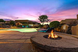 Pool at dusk featuring a patio area and a fenced backyard