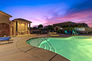 Community pool with a patio area, a fenced backyard, and ceiling fan