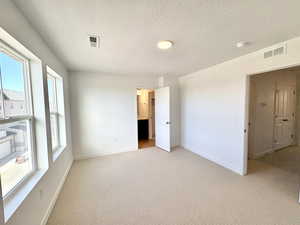 View of bedroom suite with walk-in closet and private bathroom attached