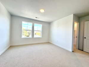 View of bedroom suite with walk-in closet and private bathroom attached