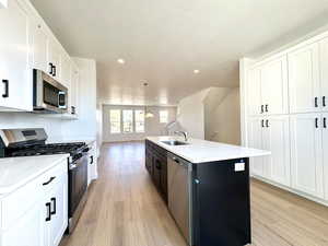 Beautiful kitchen with gas stove and stainless steel appliances. An entire wall of cabinets for a pantry gives you excellent storage space