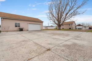 View of side of home with a garage and concrete driveway