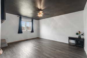 Master Bedroom featuring wood finished floors, a ceiling fan, and a textured ceiling