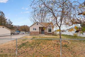Bungalow-style house with brick siding