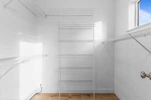 Walk in closet featuring light wood finished floors