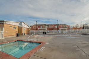 Community pool with a patio area, a residential view, and a community hot tub
