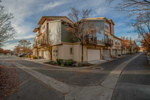 View of home's exterior featuring a residential view, stucco siding, and a garage