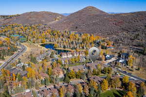 Aerial view of property's location featuring a water and mountain view and nearby suburban area