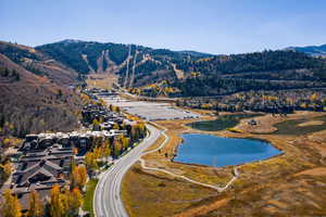 Aerial overview of property's location featuring a water and mountain view