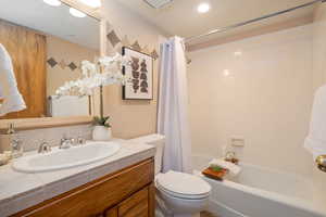 Full bath featuring vanity and shower / bathtub combination with curtain