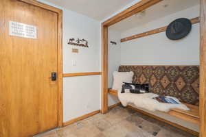 Sitting room with baseboards and stone finish floors
