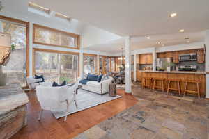 Living area featuring recessed lighting, a chandelier, and dark wood-type flooring