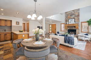 Dining space featuring a fireplace, recessed lighting, and a chandelier