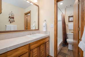 Bathroom featuring vanity and shower / tub combo with curtain