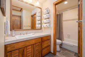 Bathroom with vanity and shower / bathtub combination with curtain