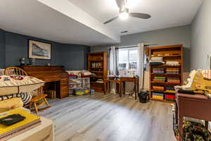 Office area featuring light wood finished floors and ceiling fan
