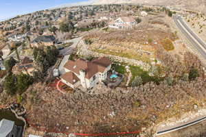 Aerial view of property and surrounding area featuring nearby suburban area