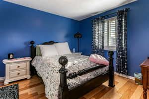 Bedroom featuring wood finished floors and a textured ceiling