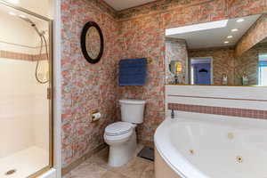 Bathroom featuring wallpapered walls, light tile patterned flooring, a shower stall, a whirlpool tub, and recessed lighting