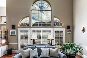 Living room featuring wood finished floors and a towering ceiling