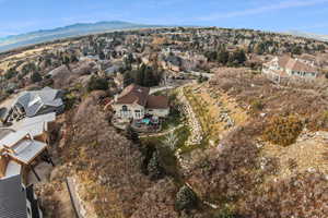 Aerial overview of property's location featuring nearby suburban area and a mountainous background