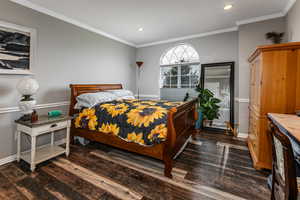 Bedroom featuring ornamental molding, dark wood-type flooring, and recessed lighting
