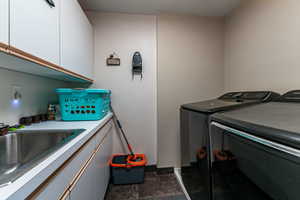 Laundry room with independent washer and dryer and cabinet space