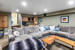 Living room featuring wet bar, recessed lighting, and carpet floors
