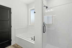 Full bathroom with a garden tub and a marble finish shower