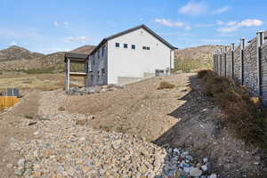 View of property exterior featuring a mountain view and stucco siding
