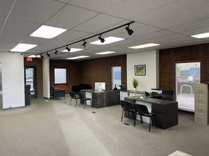 Office with brick wall and a drop ceiling