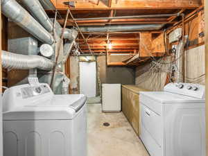 Laundry room featuring concrete floors and washer and dryer