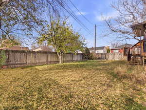 Fenced backyard with a wooden deck