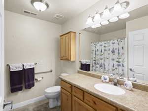 Bathroom with light tile patterned floors, vanity, and a shower with shower curtain