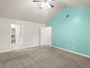 Unfurnished bedroom with carpet floors, ceiling fan, high vaulted ceiling, and a spacious closet